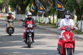 Note the two women are covered and the man in the back is in a t-shirt.